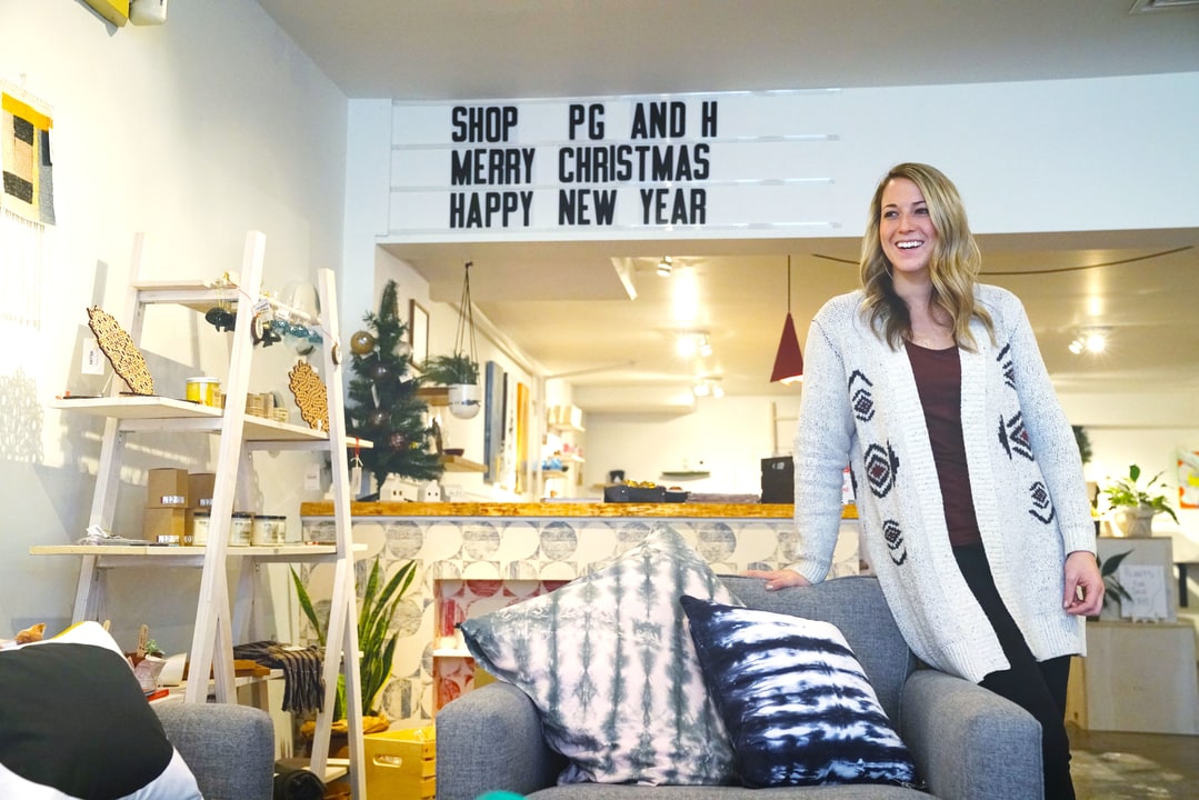 Samantha Fisher smiling and posing inside PG&H retail shop